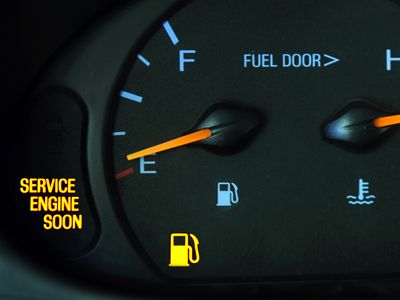 European auto repair in Denver, CO. Image of vehicle dashboard showing check engine soon and gas light on