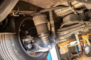 Air suspension repair in Englewood, CO by AutoImports of Denver. Close-up image of a vehicle's air suspension system, illustrating the detailed and professional repair services offered by AutoImports of Denver for high-end European vehicles.